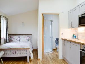 a small bedroom with a bed and a shower at Ty Nant - Uk32239 in Lower Chapel