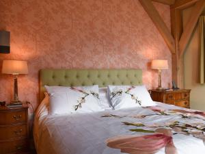 a bedroom with a large bed with two night stands at Mill Of Burncrook in Glenlivet
