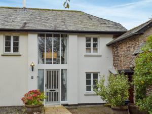 a white house with a door and windows at Moortown in Chulmleigh