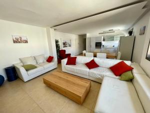 a living room with two couches and a coffee table at Beautiful 2-bedroom condo in the heart of Tel Aviv in Tel Aviv