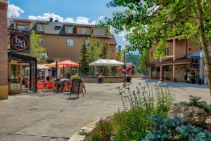 a street in a town with tables and buildings at The Corral at Breckenridge by Summit County Mountain Retreat in Breckenridge