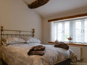 a bedroom with a bed with a robe on it at Cooper Cottage in Addingham