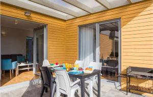 a dining room with a table and white chairs at Awesome Home In Rewal in Rewal +13 photos