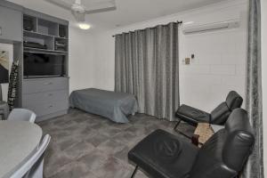 a living room with a couch and a bed at Balgal Beach Units in Rollingstone