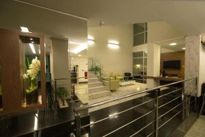 a lobby with a staircase in a building at Hotel Metropolitan in Campo Grande