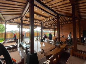 a large wooden building with people in it at d' Omah Afi 1 in Jarakan