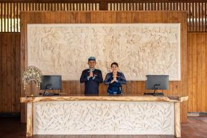 a man and a woman standing behind a large counter at Kappa Senses Ubud in Ubud