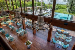 an overhead view of a restaurant with a pool and chandeliers at Kappa Senses Ubud in Ubud