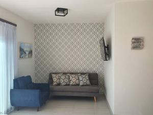 a living room with a couch and a blue chair at CASA YEYI in La Paz