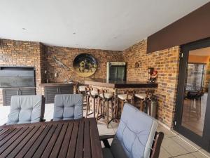 a kitchen with a table and chairs and a bar at 4 Bedroom Holiday Home, Bayhill, Whiteriver Country Estate in White River