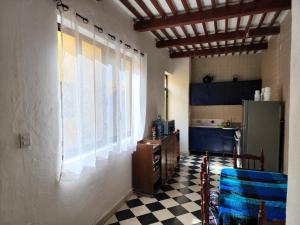 a kitchen with a checkered floor and a large window at Casa María en Centro Histórico in Campeche +11 photos