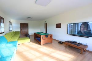 a living room with a couch and a flat screen tv at Ekain-Xokoa in Zugarramurdi