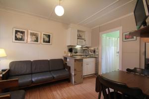 a living room with a couch and a table at Maple Leaf Motel in Littleton