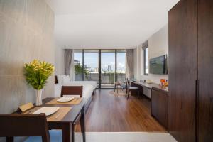 a hotel room with a bed and a dining table at Duke Casa Apartment in Da Nang