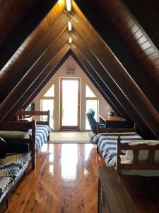 a attic room with three couches and a window at Seafarer Cottage in South Mission Beach
