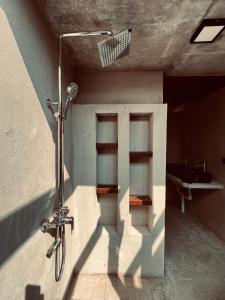 a shower in a building with a bike attached to it at Rembulan Escape - Beachfront safari tent in Penarek
