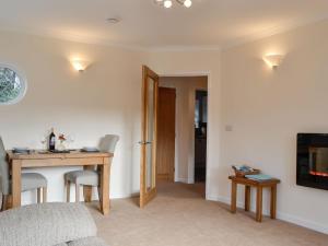 a living room with a desk and a table and a television at Wernyfed in Sennybridge