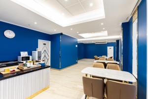 a meeting room with blue walls and a table and chairs at Siam Star Hotel in Bangkok