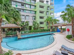 a swimming pool in front of a building at Lovely 2 Bedroom unit Pool,Gym workspace & more in Brisbane