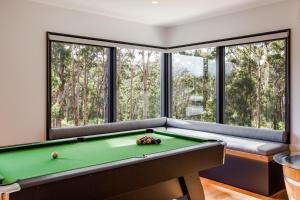 a billiard room with a pool table and windows at Kaya Karri in Margaret River Town