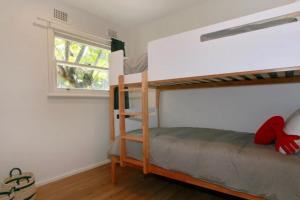 a bedroom with two bunk beds and a window at Sahara Trails Cabin 2 WiFi Air Conditioning Horse Riding and much more in Anna Bay