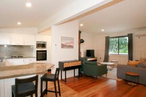 a kitchen and living room with a table and a couch at Sahara Trails House WiFi Air Conditioning Horse Riding and much more in Anna Bay