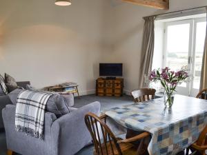 a living room with a table and a couch at Little Barn Tynely Farm in Ellingham
