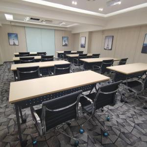 an empty classroom with tables and chairs in it at Hotel Aman Kuala Lumpur in Kuala Lumpur