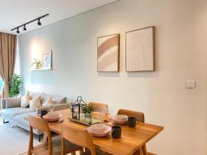 a living room with a table and a couch at De Sky Suites KLCC Kuala Lumpur in Kuala Lumpur