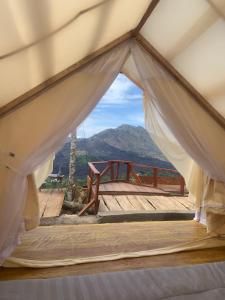 a tent with a view of a mountain at Tukadsari camping in Kintamani