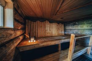 an interior of a wooden cabin with a bench in it at Lapland Lodge in Tepsa