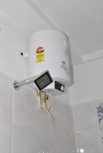 a device on the wall of a bathroom at HOTEL THE ROYAL PARK in Bangalore