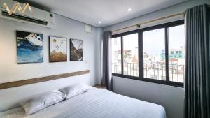 Postel nebo postele na pokoji v ubytování VNAHOMES Serviced Apartment