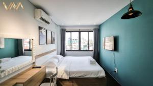 Postel nebo postele na pokoji v ubytování VNAHOMES Serviced Apartment