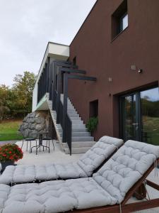 a group of white couches sitting outside of a building at VILABELA in Sežana