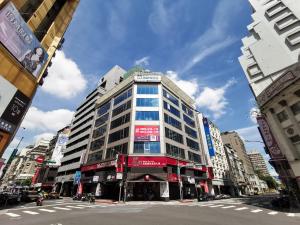 a tall building on a street in a city at Inn Cube - Ximen in Taipei