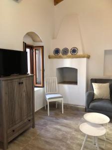 a living room with a couch and a tv at Alicia's Traditional Home In Paradisi in Paradeísion