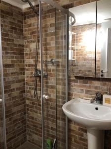 a bathroom with a sink and a glass shower at Alicia's Traditional Home In Paradisi in Paradeísion