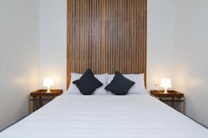 een slaapkamer met een groot wit bed met 2 lampen bij Z Hostel in Manilla +37 foto's