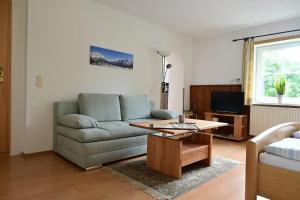 a living room with a couch and a coffee table at Haus Marion in Ehrwald
