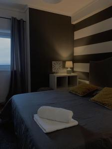a bedroom with a bed with a white pillow on it at Ria do Sal in Aveiro