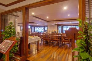 a restaurant with a dining room with tables and chairs at Cheathata CTS Hotel Siem Reap in Siem Reap