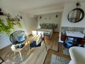 a living room with a bed and a sink at Arche de Lanoë jacuzzi in Labastide-Saint-Pierre