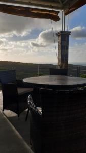a table and chairs on a patio with a view at Residence Bethel in Rodrigues Island