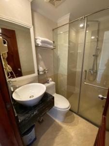 a bathroom with a sink and a toilet and a shower at Khách Sạn A83Hotel in Hanoi