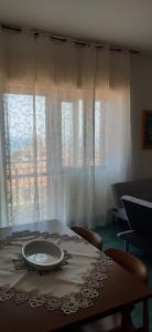 a table with a plate on top of it with a window at Al Settimo Cielo Termoli in Termoli