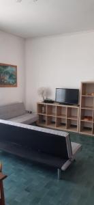 a living room with a couch and a flat screen tv at Al Settimo Cielo Termoli in Termoli