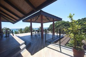 een paviljoen met tafels en stoelen op een terras bij Signature Boracay Punta Rosa formerly Punta Rosa Boutique Hotel in Boracay