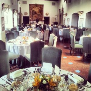 a room filled with tables and chairs with white tablecloths at Parador de Oropesa in Oropesa +91 photos