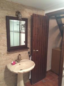 a bathroom with a sink and a mirror at Casa Juan in Orihuela del Tremedal
